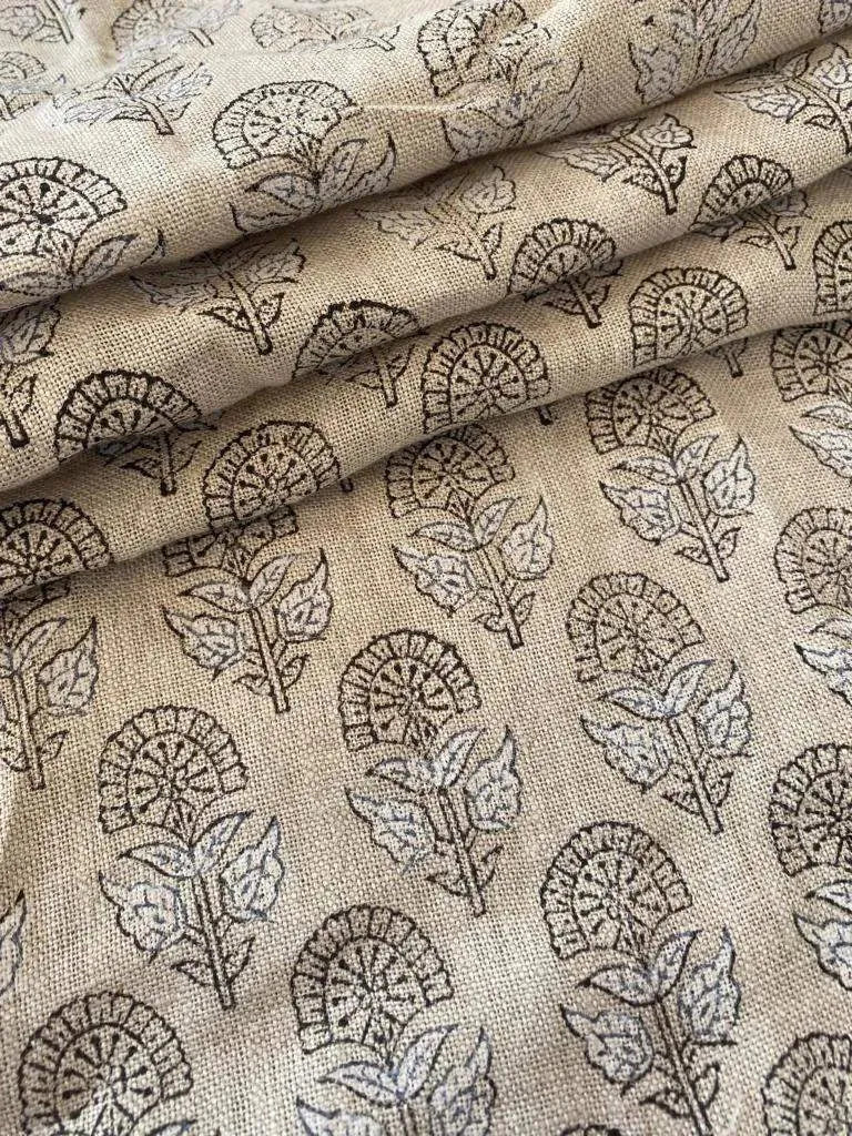 A curated stack of folded pre-cut fabric remnants, featuring hand-block printed linen and cotton textiles in various botanical patterns for the Thread to Form sustainable archive.