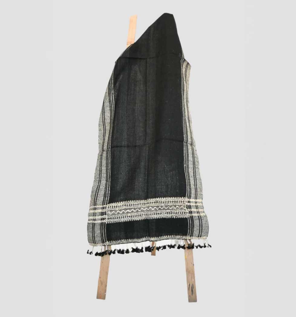 Black and gray patterned scarf with tassels on a white background