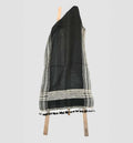 Black and gray patterned scarf with tassels on a white background