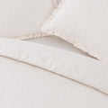 Close-up of a textured white fabric with a subtle pattern