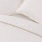 Close-up of a textured white fabric with a subtle pattern