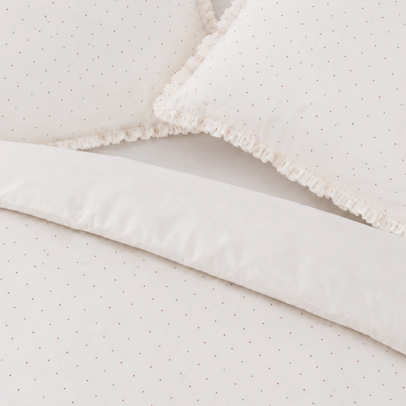 Close-up of a textured white fabric with a subtle pattern