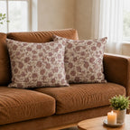 Hand block-printed linen pillow covers featuring purple and plum botanical floral vines on a natural ground.