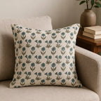 Hand block printed linen pillow cover featuring sage green and blue floral buti motifs on a natural ground.