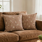 Blush pink linen pillow covers featuring hand block-printed beige and plum wine botanical floral vine patterns.