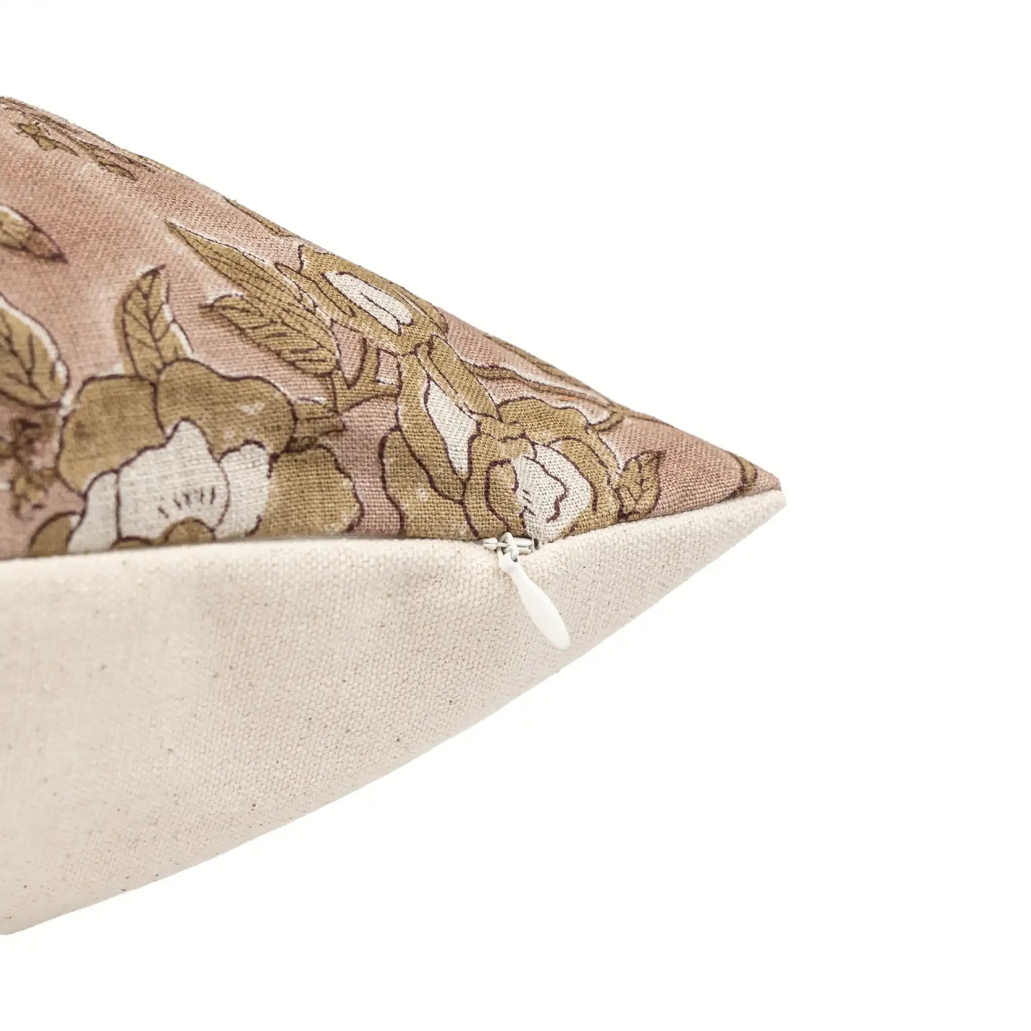 Blush pink linen pillow cover with hand-blocked beige and plum floral vine pattern and hidden zipper closure.