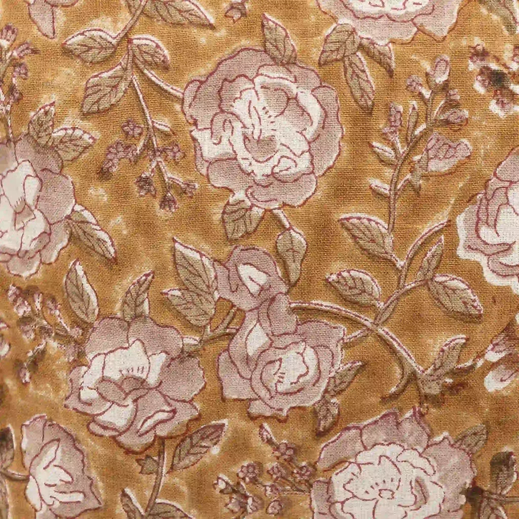 Mustard linen pillow cover featuring a hand-block printed botanical floral vine motif in pink beige and red.
