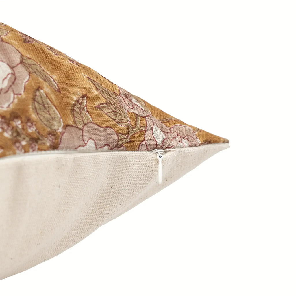 Hand block printed mustard linen pillow cover with pink beige floral vine motif and hidden zipper closure.