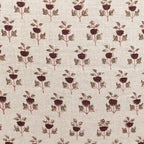 Hand block printed natural linen pillow cover featuring a plum and red floral buti motif on a textured neutral ground.