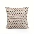 Hand block printed natural linen pillow cover featuring a plum and red ditsy floral buti motif on a neutral ground.