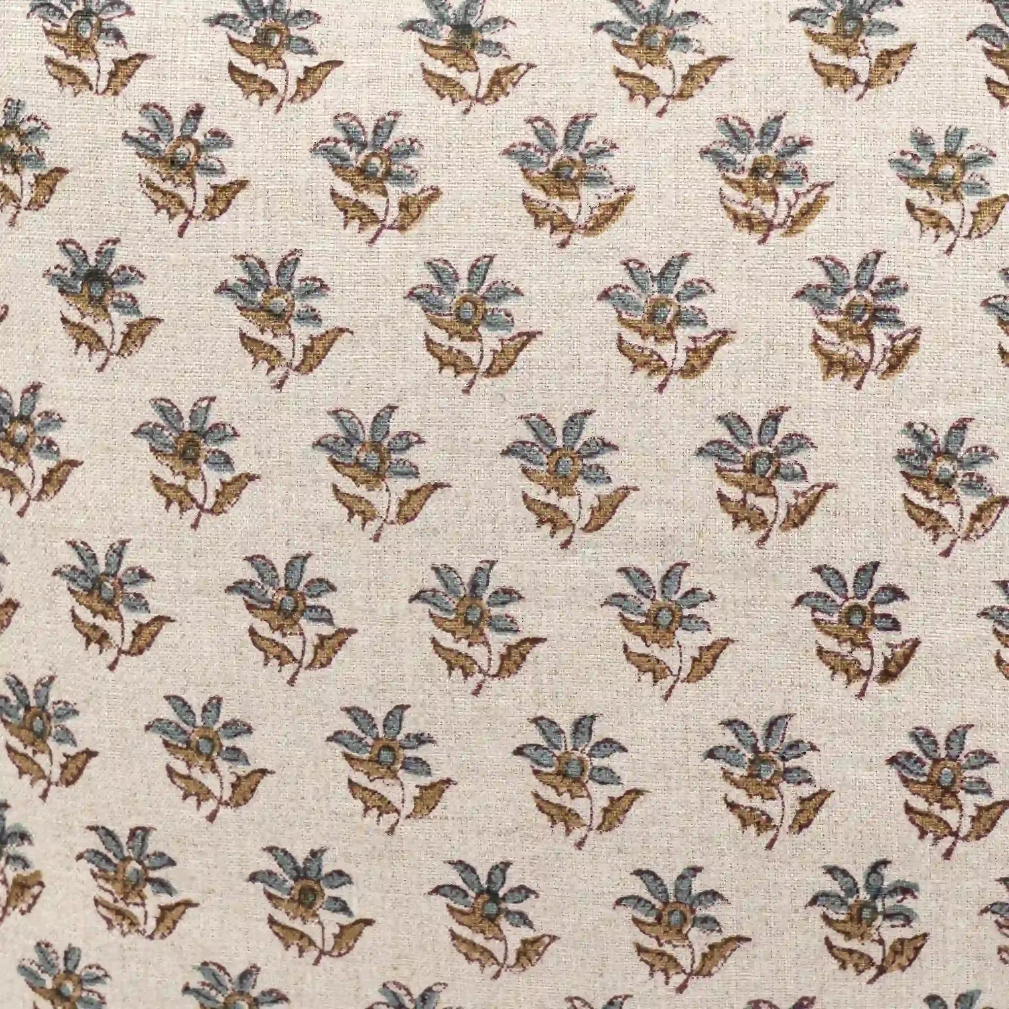 Hand block printed linen pillow cover featuring a sage green and blue floral buti pattern on a natural ground.