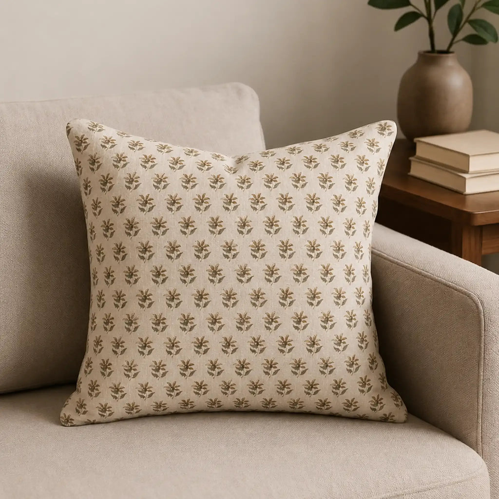 Natural linen pillow cover featuring a hand block-printed sage green and beige floral buti pattern on a neutral ground.
