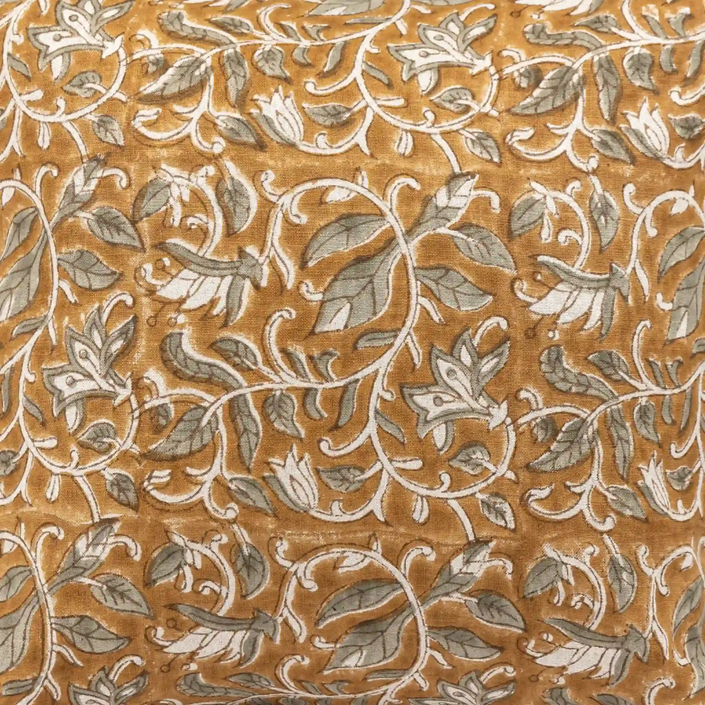 Mustard linen pillow cover featuring hand block-printed pale green floral vines with brown outlines.
