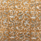 Mustard linen pillow cover featuring hand block-printed pale green floral vines with brown outlines.