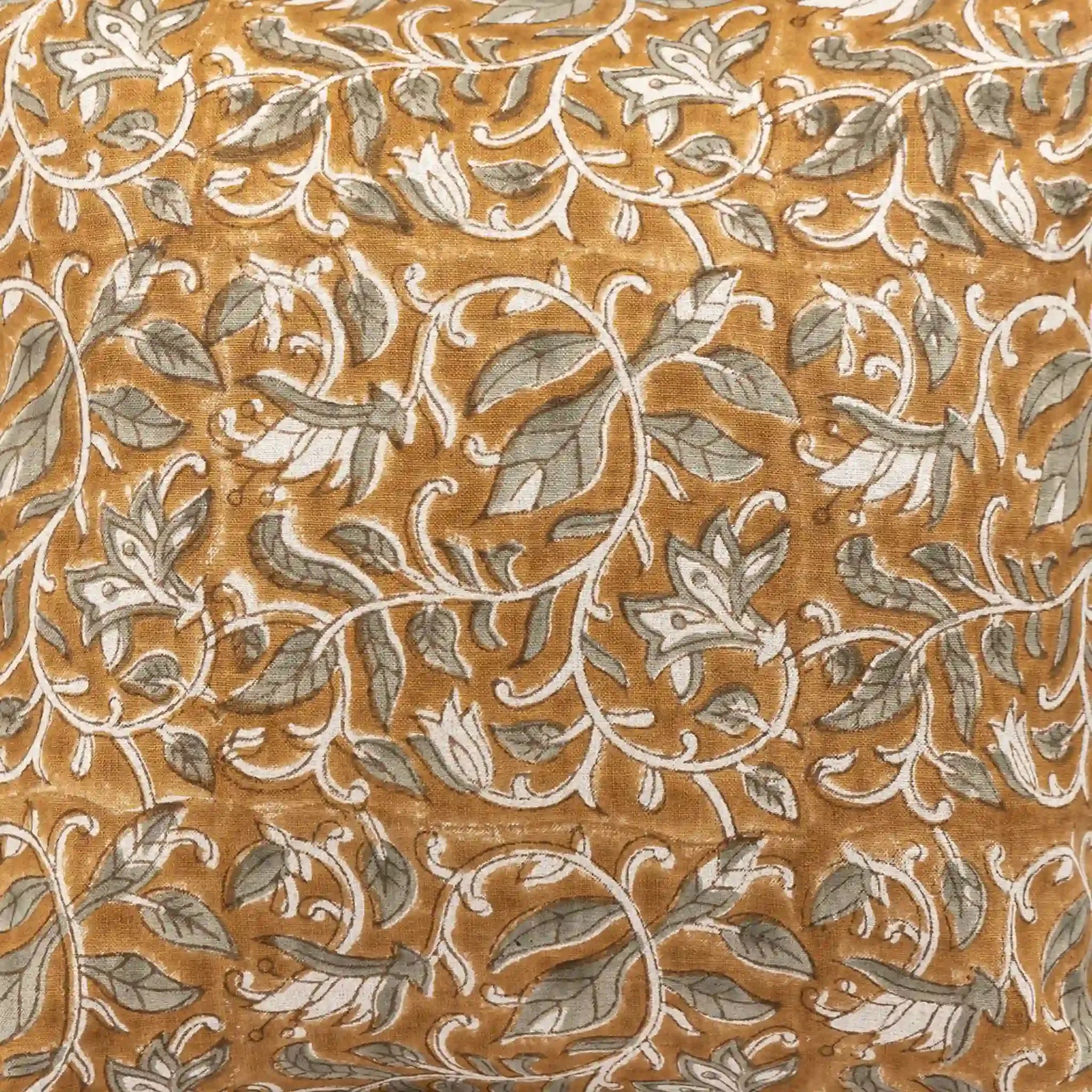 Mustard linen pillow cover featuring hand block-printed pale green floral vines with brown outlines.