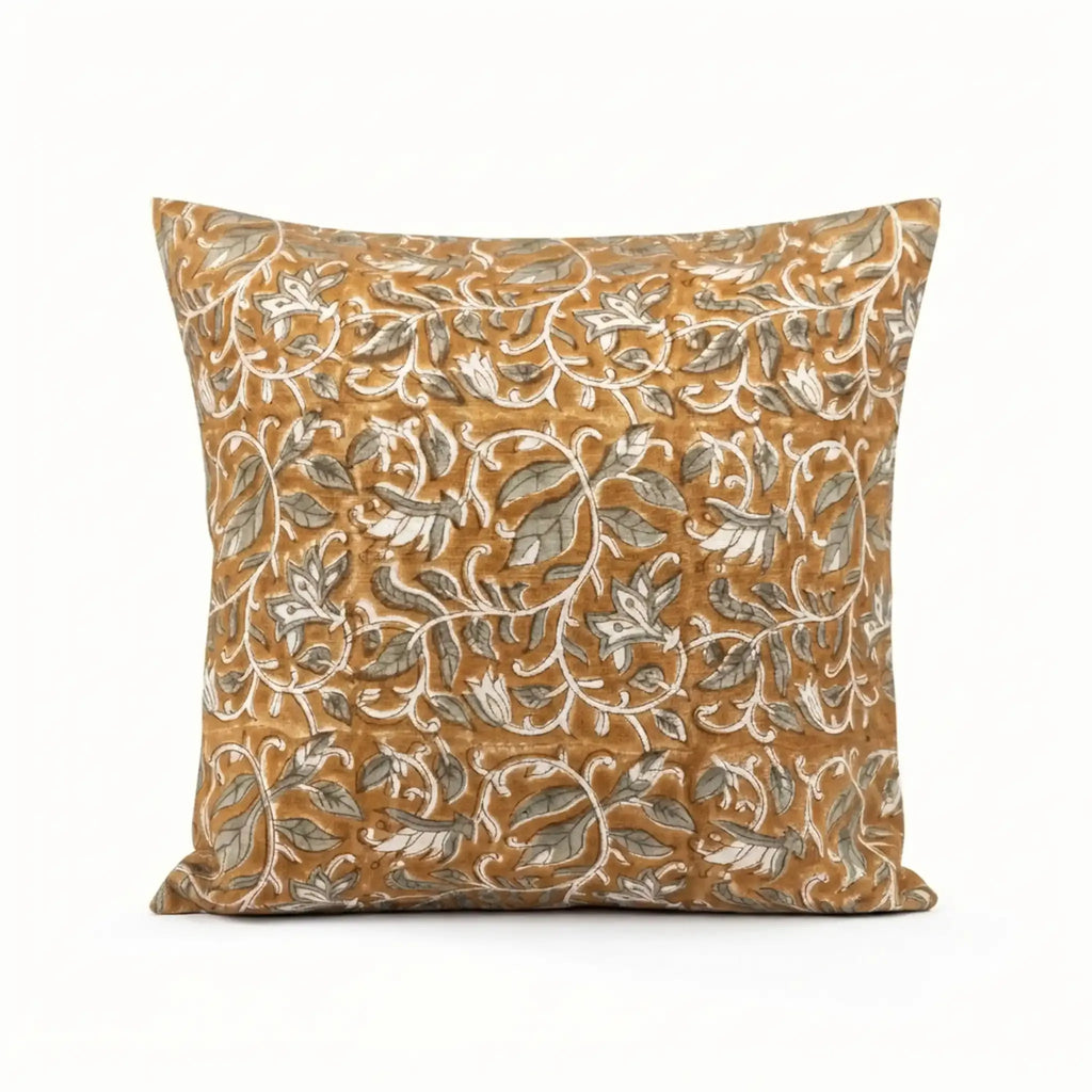 Mustard linen pillow cover with hand-blocked pale green and brown floral vine pattern.