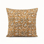 Mustard linen pillow cover with hand-blocked pale green and brown floral vine pattern.