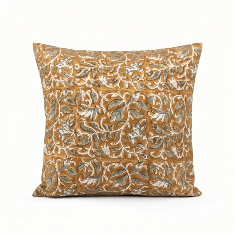 Mustard linen pillow cover with hand-blocked pale green and brown floral vine pattern.