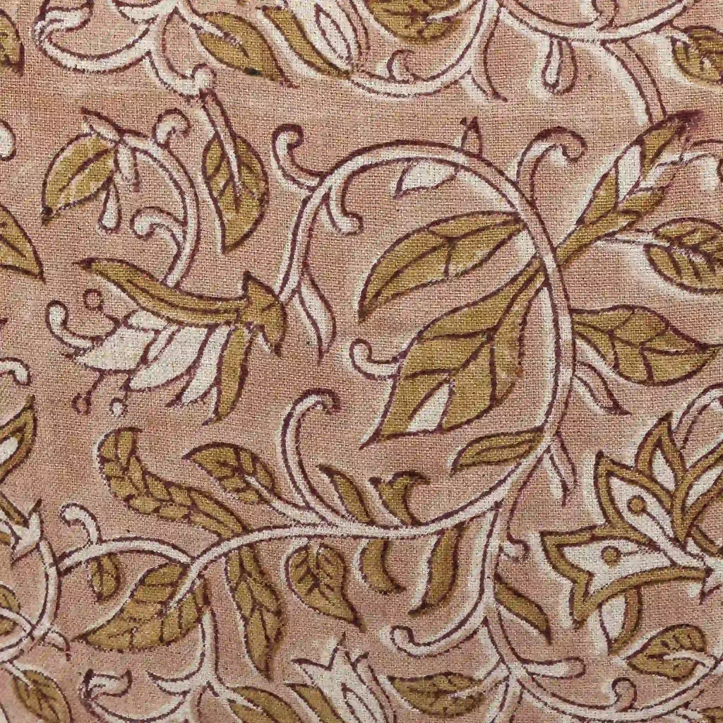 Hand block printed linen pillow cover featuring a floral vine motif in beige and plum wine on a dawn pink background.