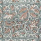 Hand block printed linen pillow cover featuring blush pink floral vines on an ice blue background.