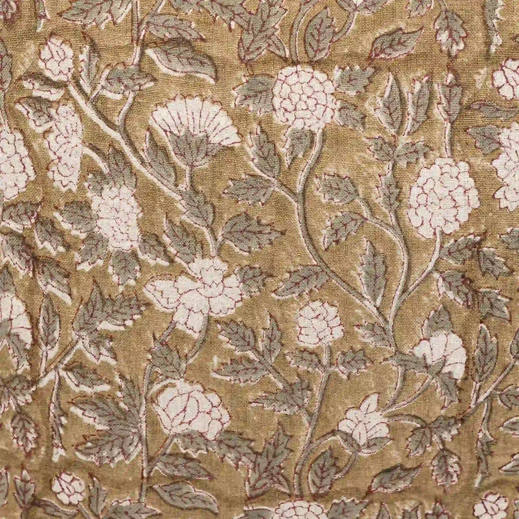 Hand block printed beige linen pillow cover with pale green floral vines and red outlines.