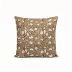 Hand block printed beige linen pillow cover featuring a pale green and red floral vine motif on a textured fabric.