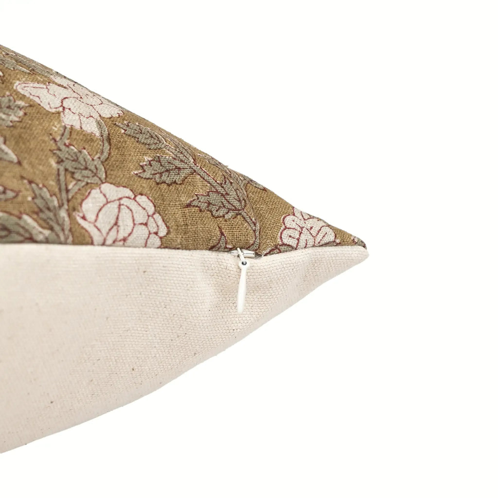 Hand block printed beige linen pillow cover featuring pale green and red floral vine motifs with a hidden zipper closure.