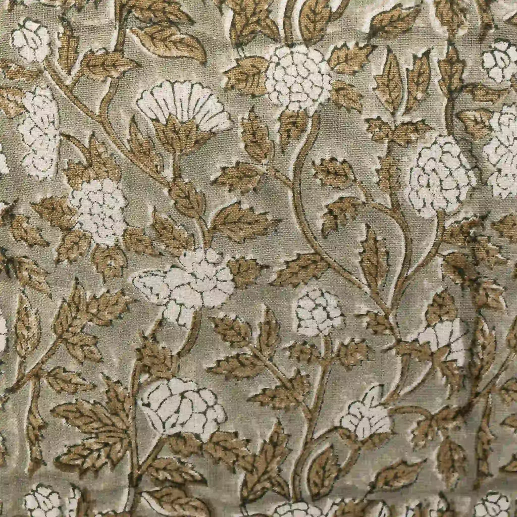Hand block printed pale green linen pillow cover featuring beige floral rosettes and olive green vine motifs.