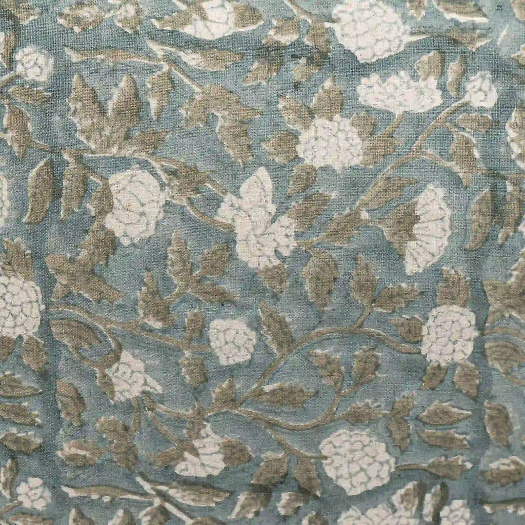 Hand block printed linen pillow cover in ice blue with pale green botanical floral vine patterns.