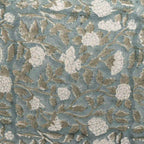 Hand block printed linen pillow cover in ice blue with pale green botanical floral vine patterns.