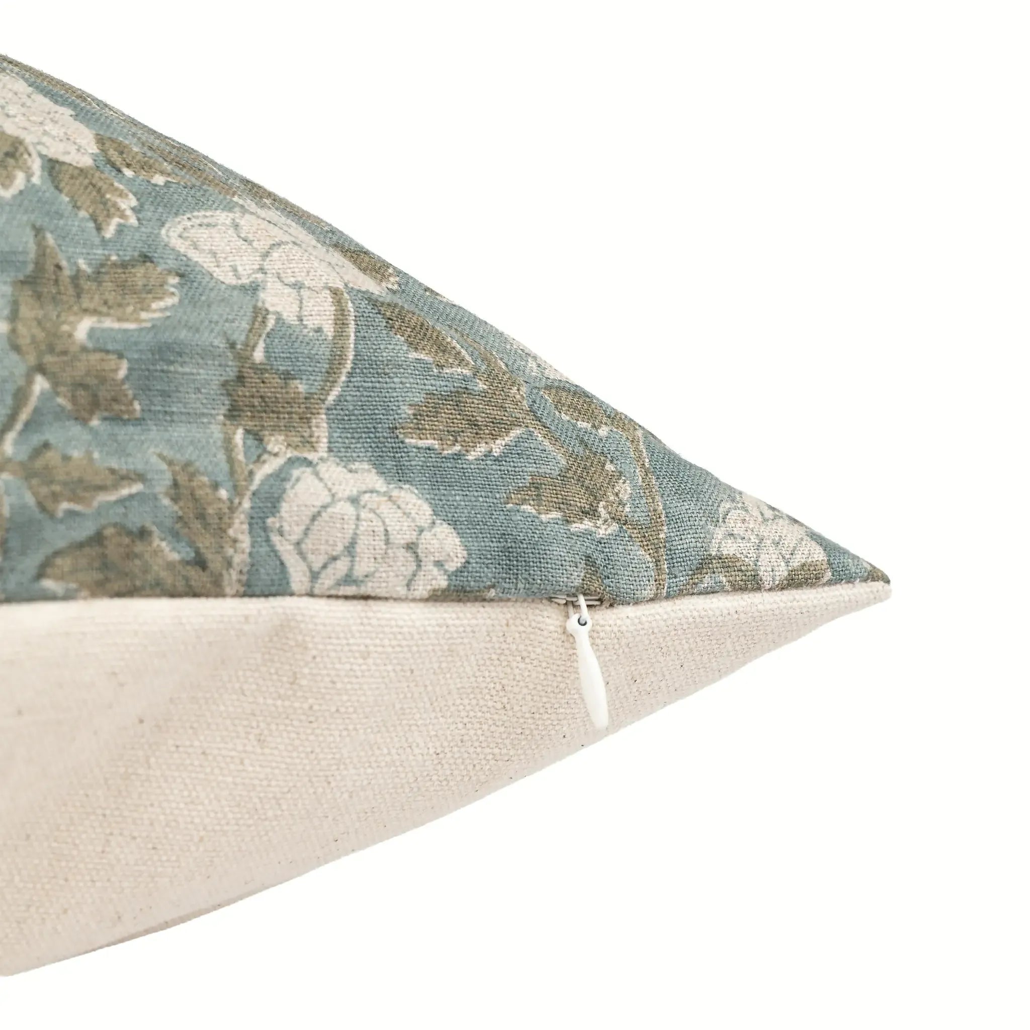 Hand block printed ice blue linen pillow cover featuring pale green floral vines and a concealed zipper closure.