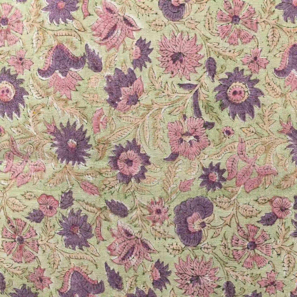Hand block printed linen pillow cover featuring purple and olive floral vine motifs on a sage green background.