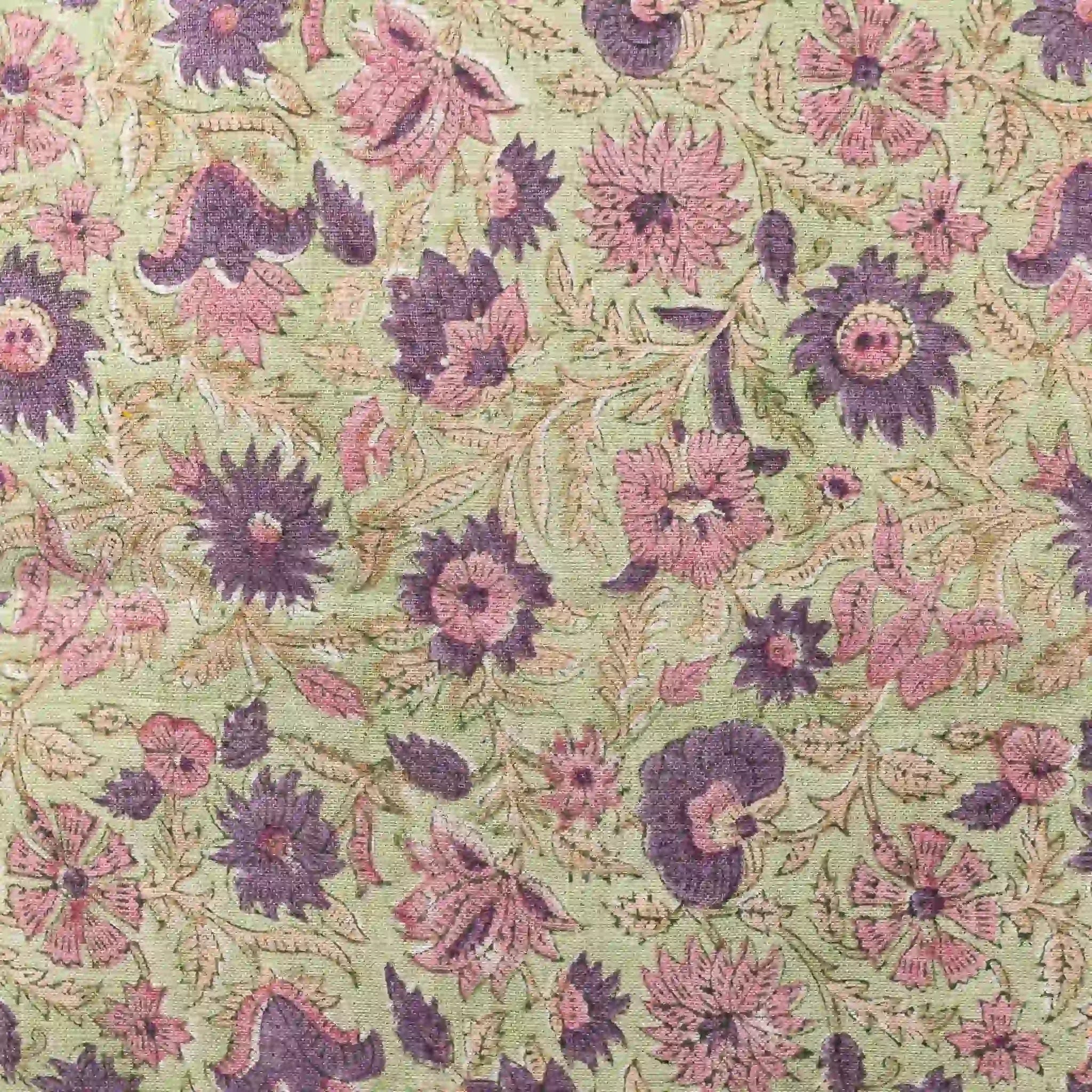 Hand block printed linen pillow cover featuring purple and olive floral vine motifs on a sage green background.