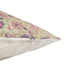 Sage green linen pillow cover with hand-blocked purple and olive floral vine print and a hidden zipper closure.