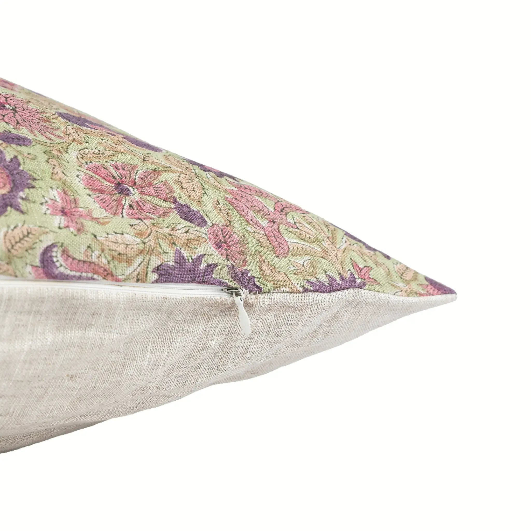 Sage green linen pillow cover with hand-blocked purple and olive floral vine print and a hidden zipper closure.