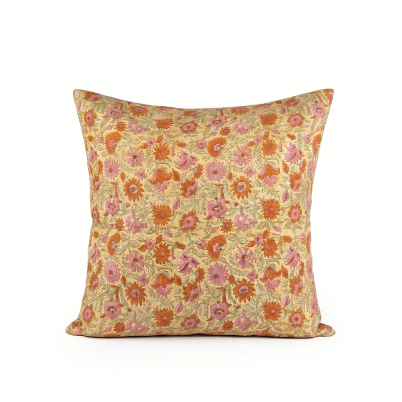 Hand block printed linen pillow cover in lemon yellow with orange and dusk orange botanical floral vine patterns.