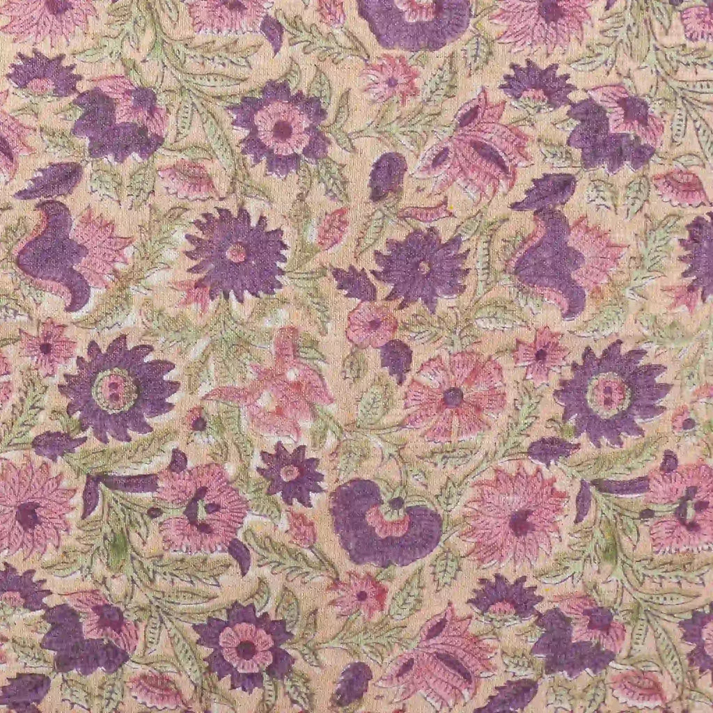 Hand block printed linen pillow cover featuring blush pink and olive green floral vines on a light beige ground.
