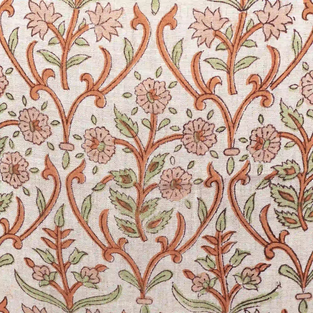 Hand block printed linen pillow cover featuring a botanical floral vine motif in dusk orange and brown on natural ground.