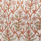 Hand block printed linen pillow cover featuring a botanical floral vine motif in dusk orange and brown on natural ground.