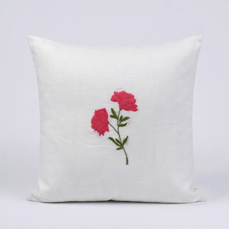 White cotton slub cushion cover featuring a delicate pink and green embroidered botanical fruiting vine design.