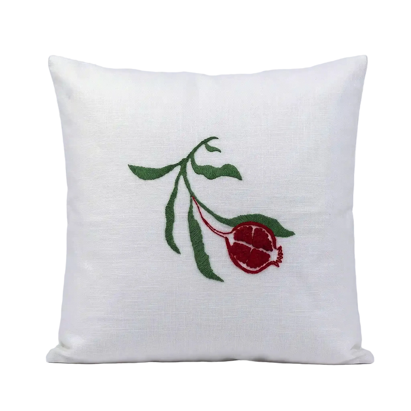 White cotton slub cushion cover featuring a red and green embroidered pomegranate botanical motif.