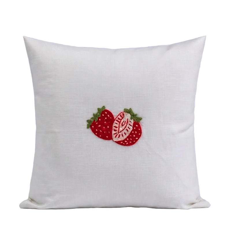 White cotton slub cushion cover featuring delicate pink and red embroidered strawberry botanical detail.