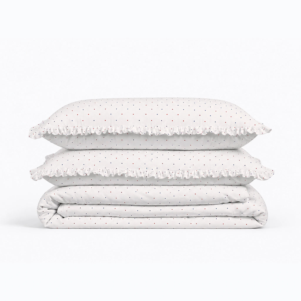 Stack of polka dot bedding on a white background