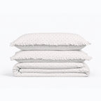 Stack of polka dot bedding on a white background