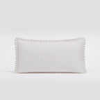 Rectangular pillow with a subtle pattern on a light gray background
