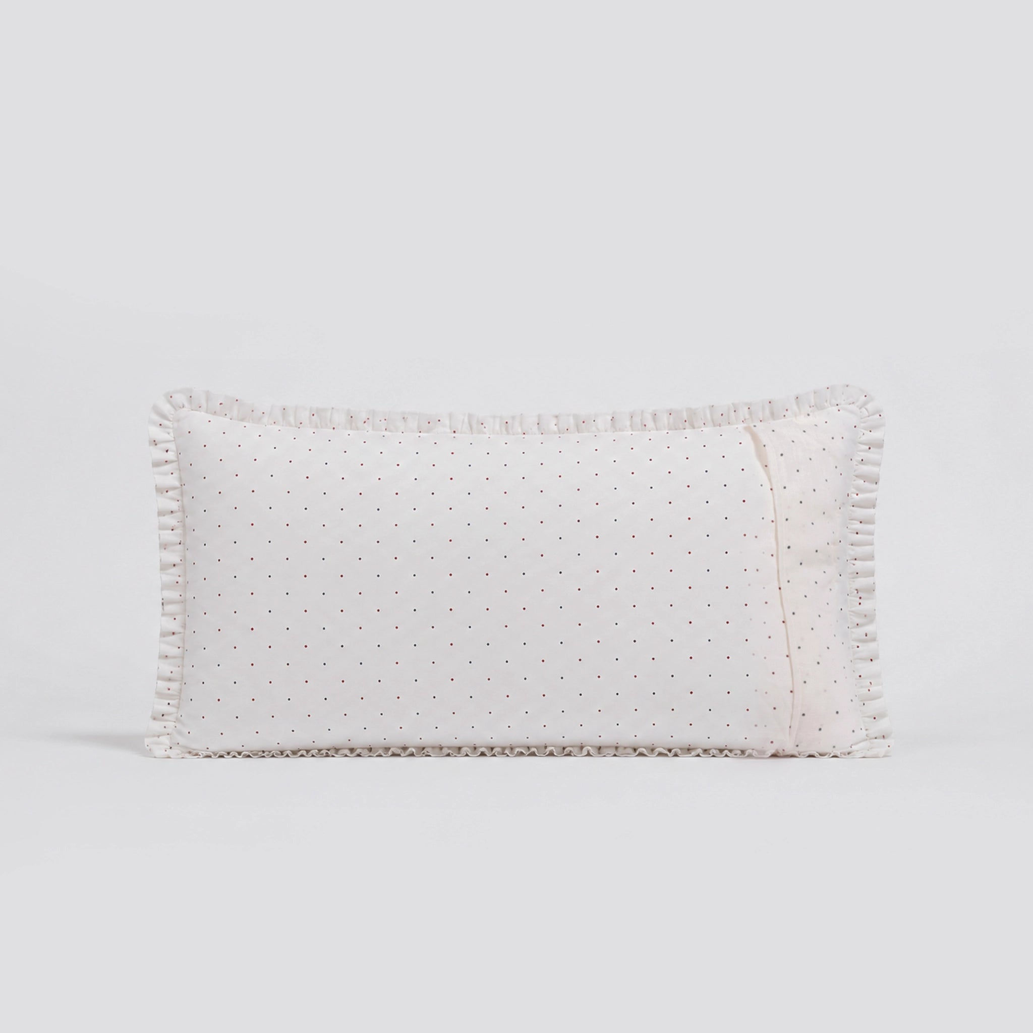 Rectangular white pillow with textured pattern on a light gray background