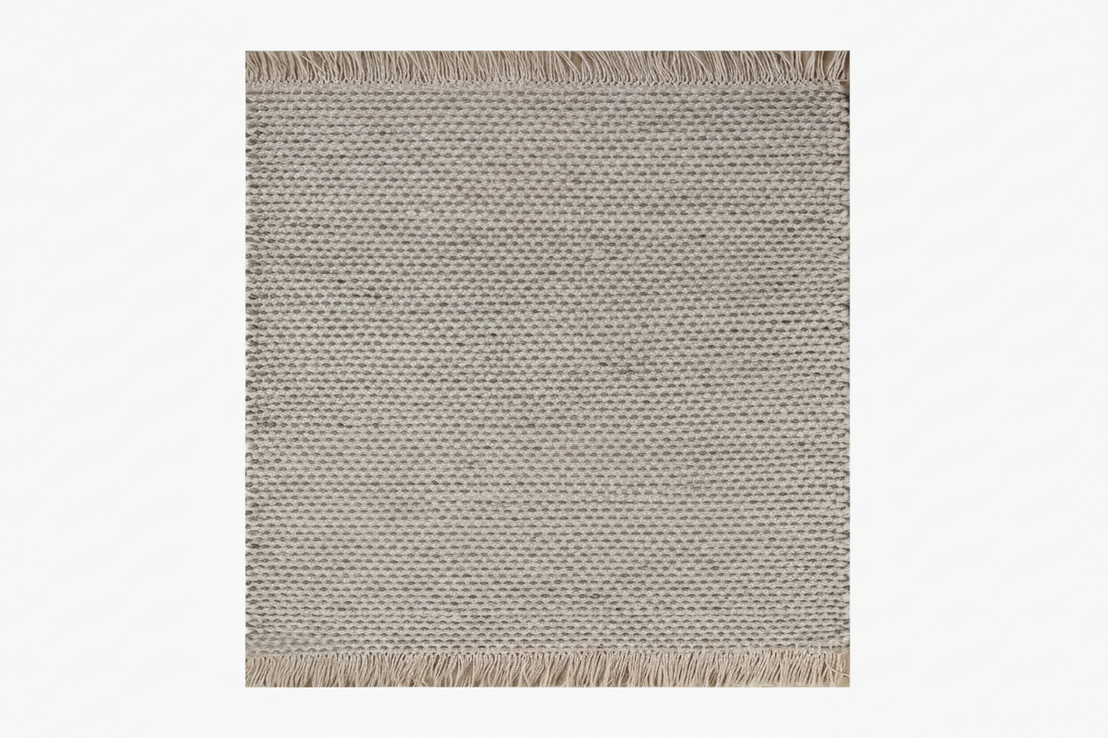 Textured area rug with fringes on a plain background