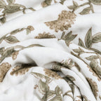 Close-up of white fabric with brown floral pattern