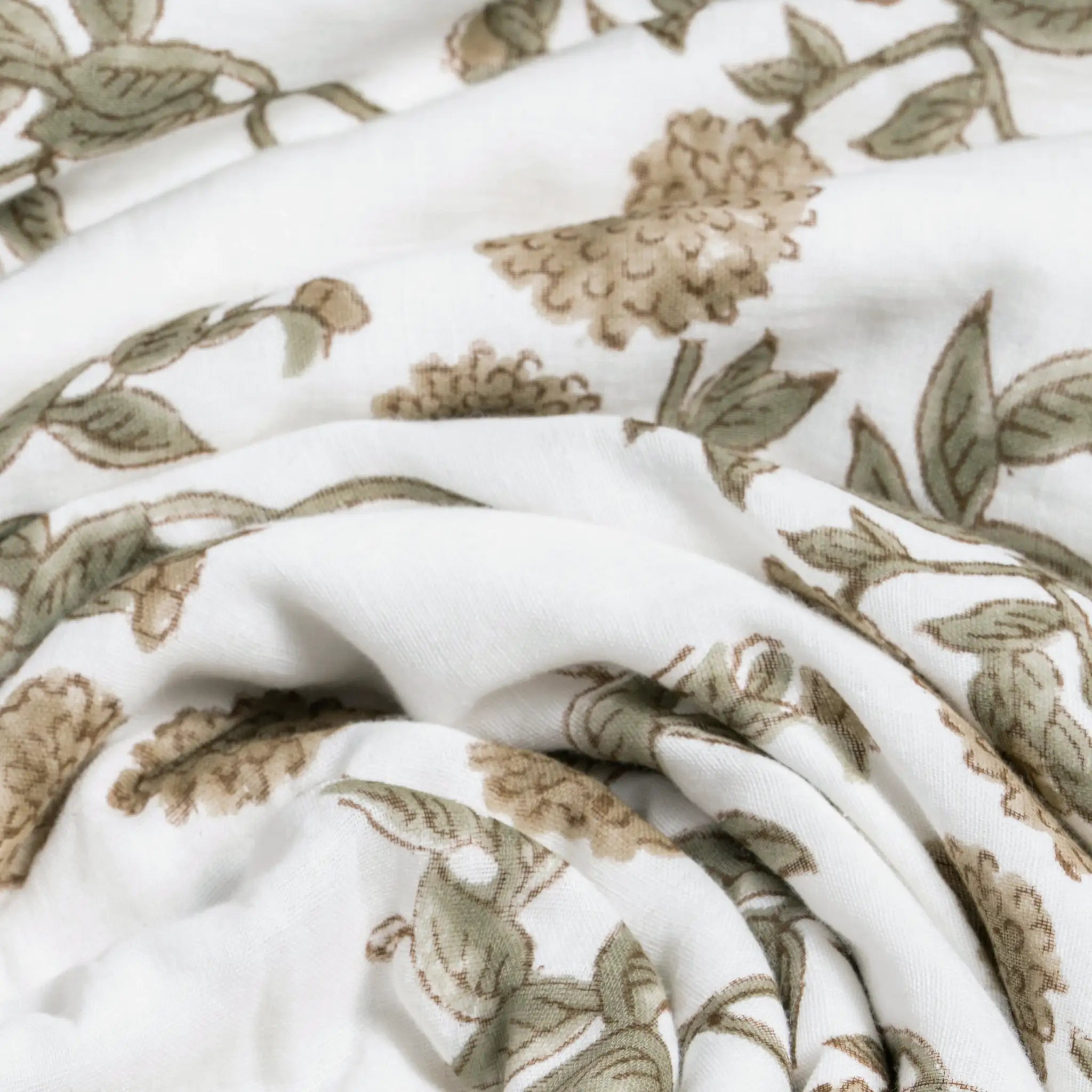 Close-up of white fabric with brown floral pattern