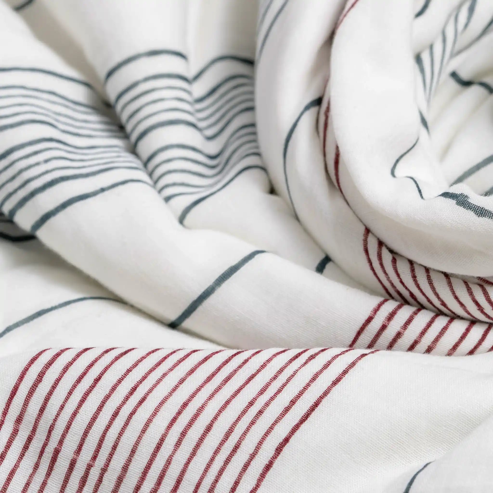 Close-up of striped fabric with red and blue lines on a white background